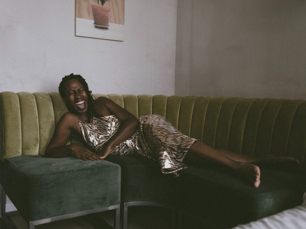 Woman relaxing on green couch