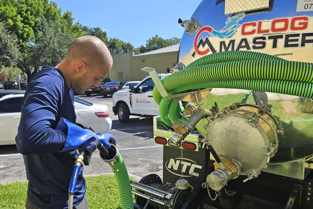 ClogMasters technician working with drain cleaning equipment