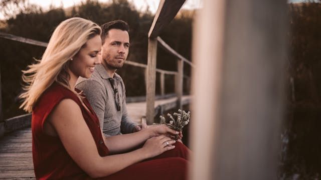 Romantic couple enjoying intimate moment together on wooden deck